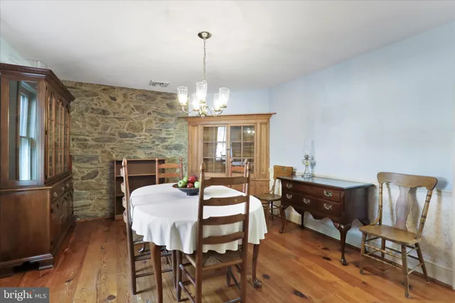a view of a dining room with furniture wooden floor and chandelier