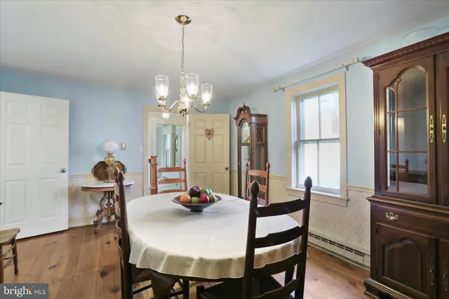 a view of a dining room with furniture and chandelier