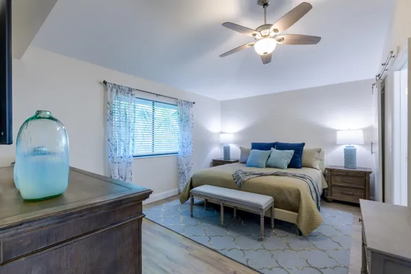 a bedroom with a bed and a chandelier