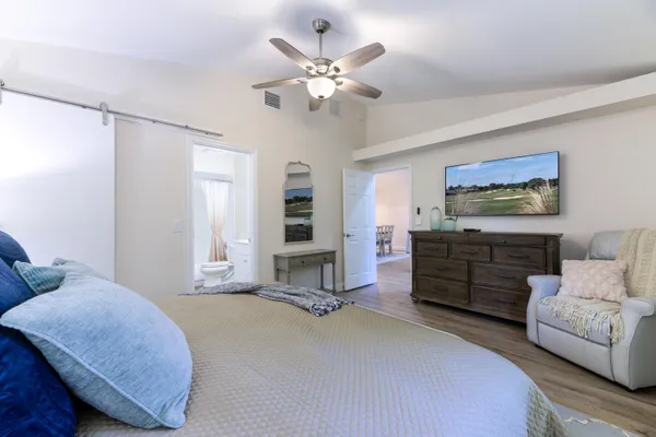 a bedroom with a bed dresser and a window