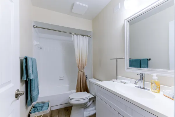 a bathroom with a granite countertop sink toilet and shower