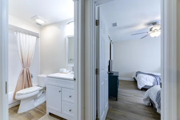 a bathroom with a sink a toilet and a large mirror