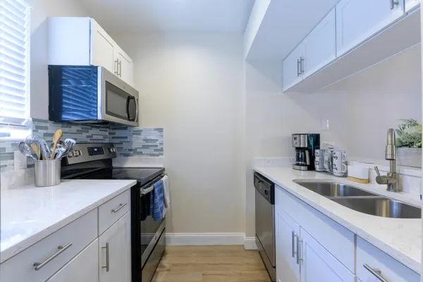 a kitchen with a sink stove and microwave