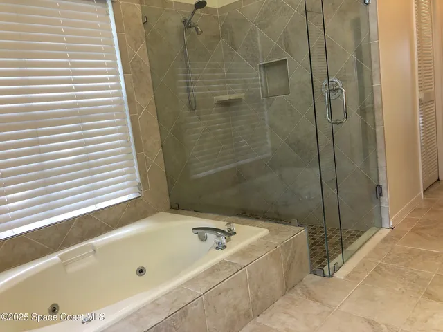 a bathroom with a tub and a shower