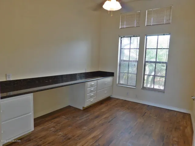 a room with hard wood floors and a window
