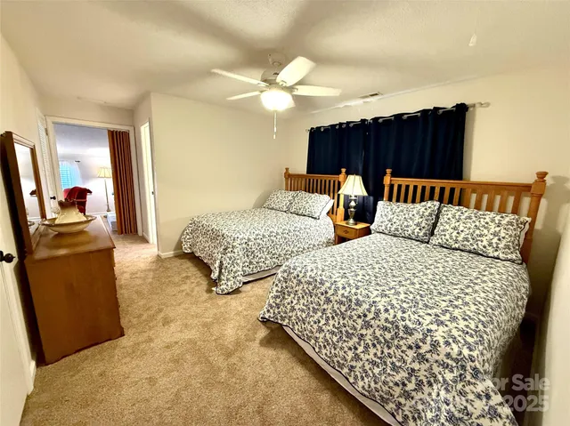 a bedroom with bed and a chandelier