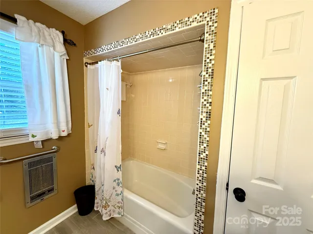 a bathroom with a shower and a sink
