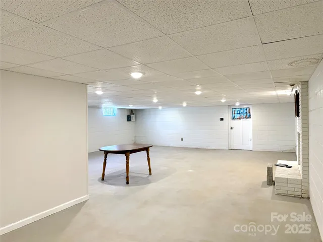 a view of a livingroom with a couch and a potted plant
