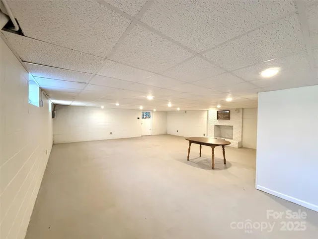 a view of a room with a table and chairs
