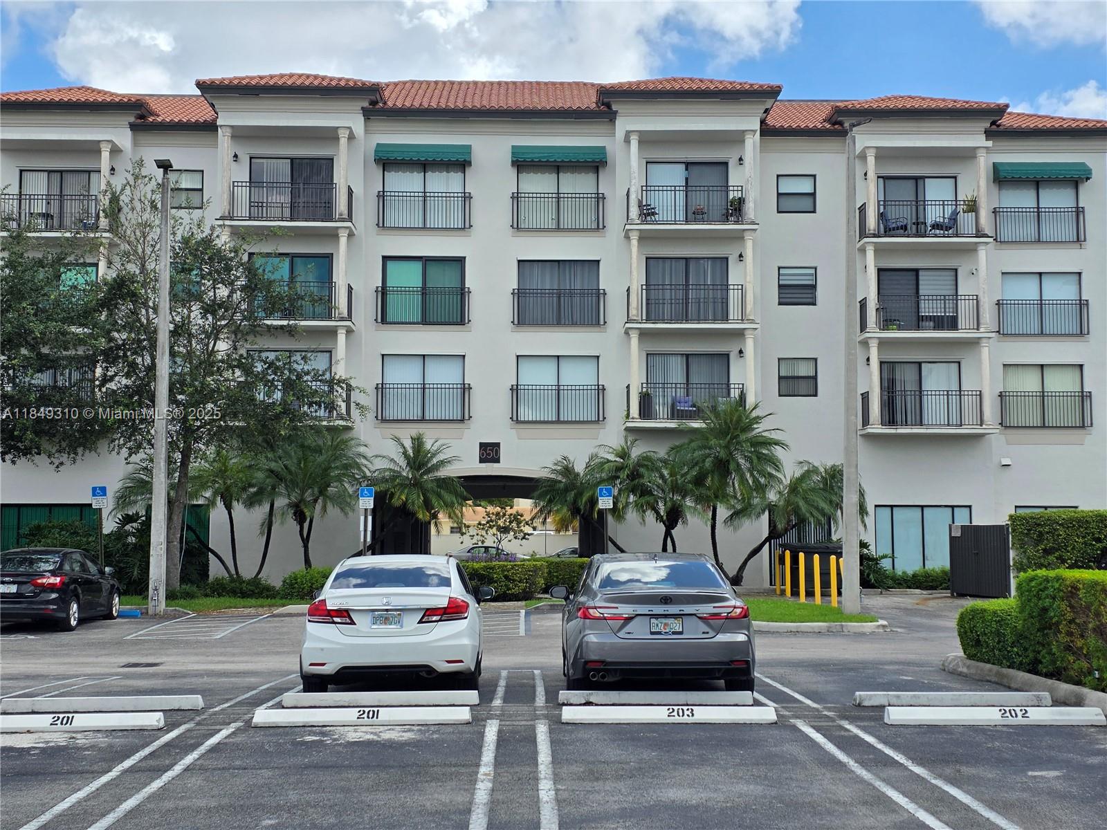 650 Palm Avenue, Unit 2B6 Hialeah, FL 33010 - Photo 1 of 12 a view of a cars parked in front of a building