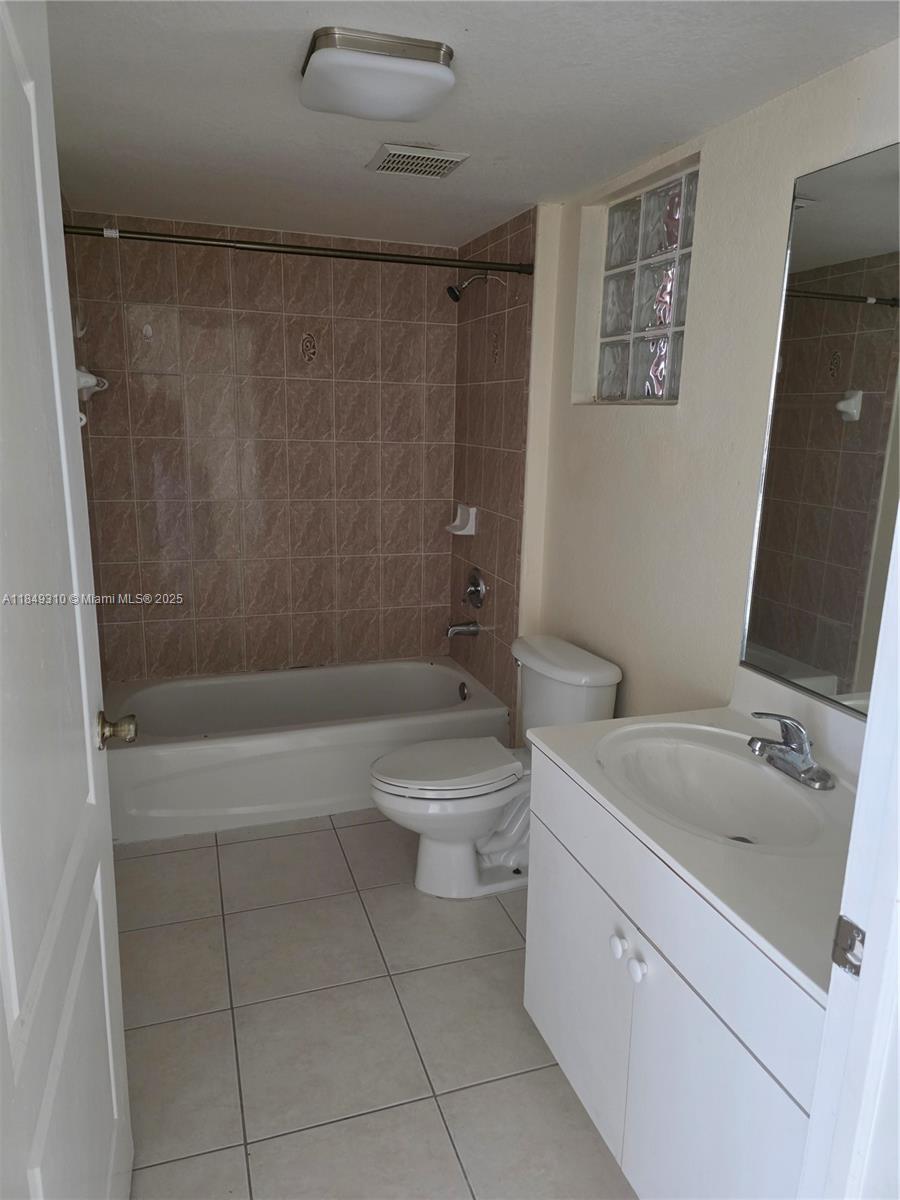 650 Palm Avenue, Unit 2B6 Hialeah, FL 33010 - Photo 12 of 12 a bathroom with a sink a toilet and shower