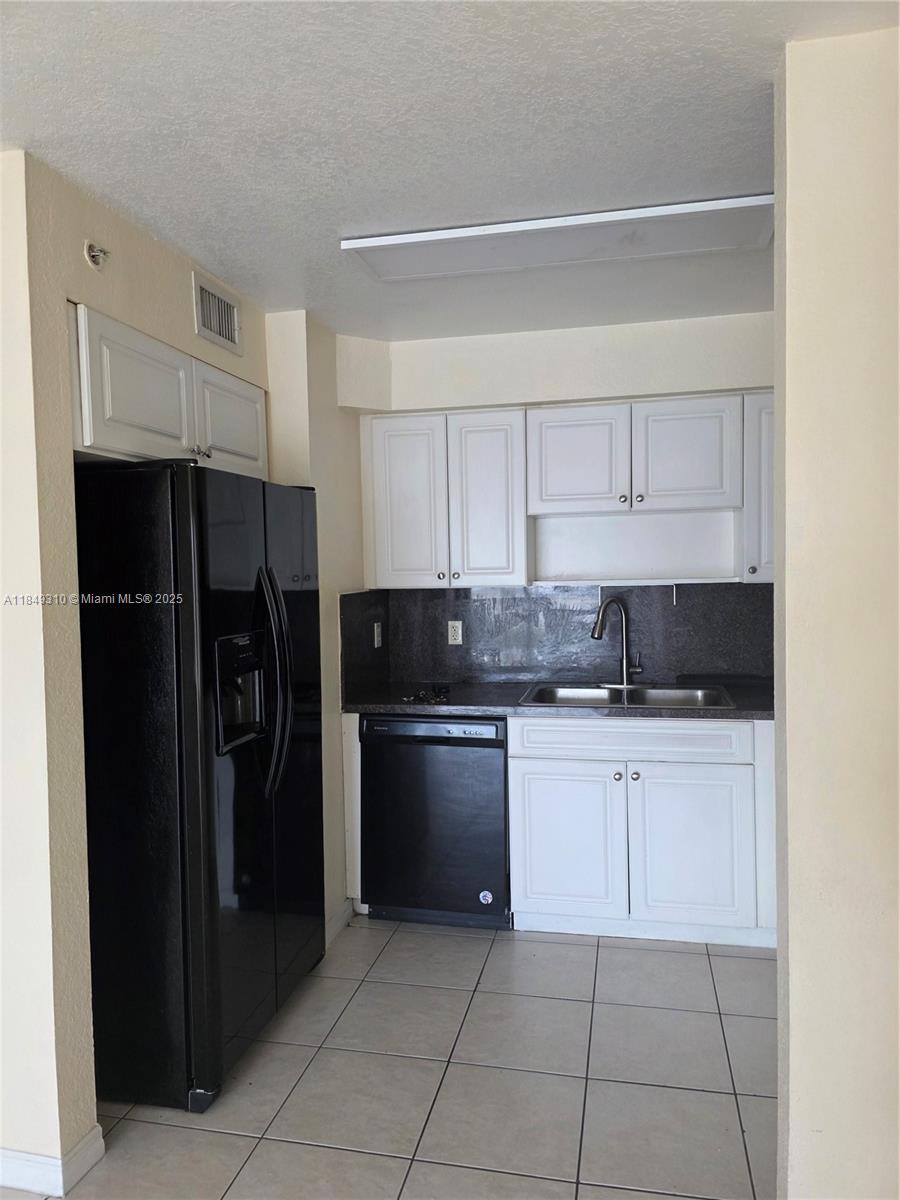 650 Palm Avenue, Unit 2B6 Hialeah, FL 33010 - Photo 5 of 12 a kitchen with a refrigerator and a sink