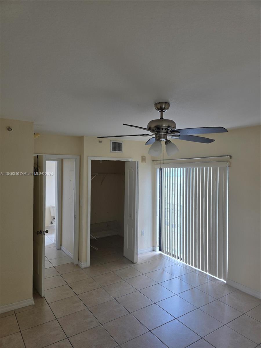 650 Palm Avenue, Unit 2B6 Hialeah, FL 33010 - Photo 8 of 12 a view of a livingroom with a ceiling fan & entryway