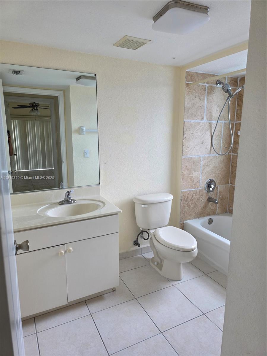 650 Palm Avenue, Unit 2B6 Hialeah, FL 33010 - Photo 10 of 12 a bathroom with a toilet sink and mirror
