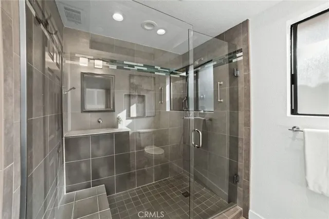 a bathroom with a shower and a mirror