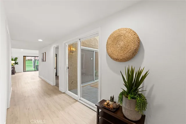 an entryway with wooden floor and a rug