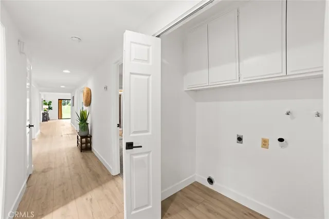 a view of a hallway with wooden floor and entryway