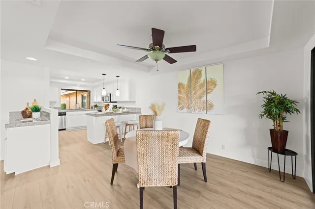 a view of a dining room with furniture and a potted plant