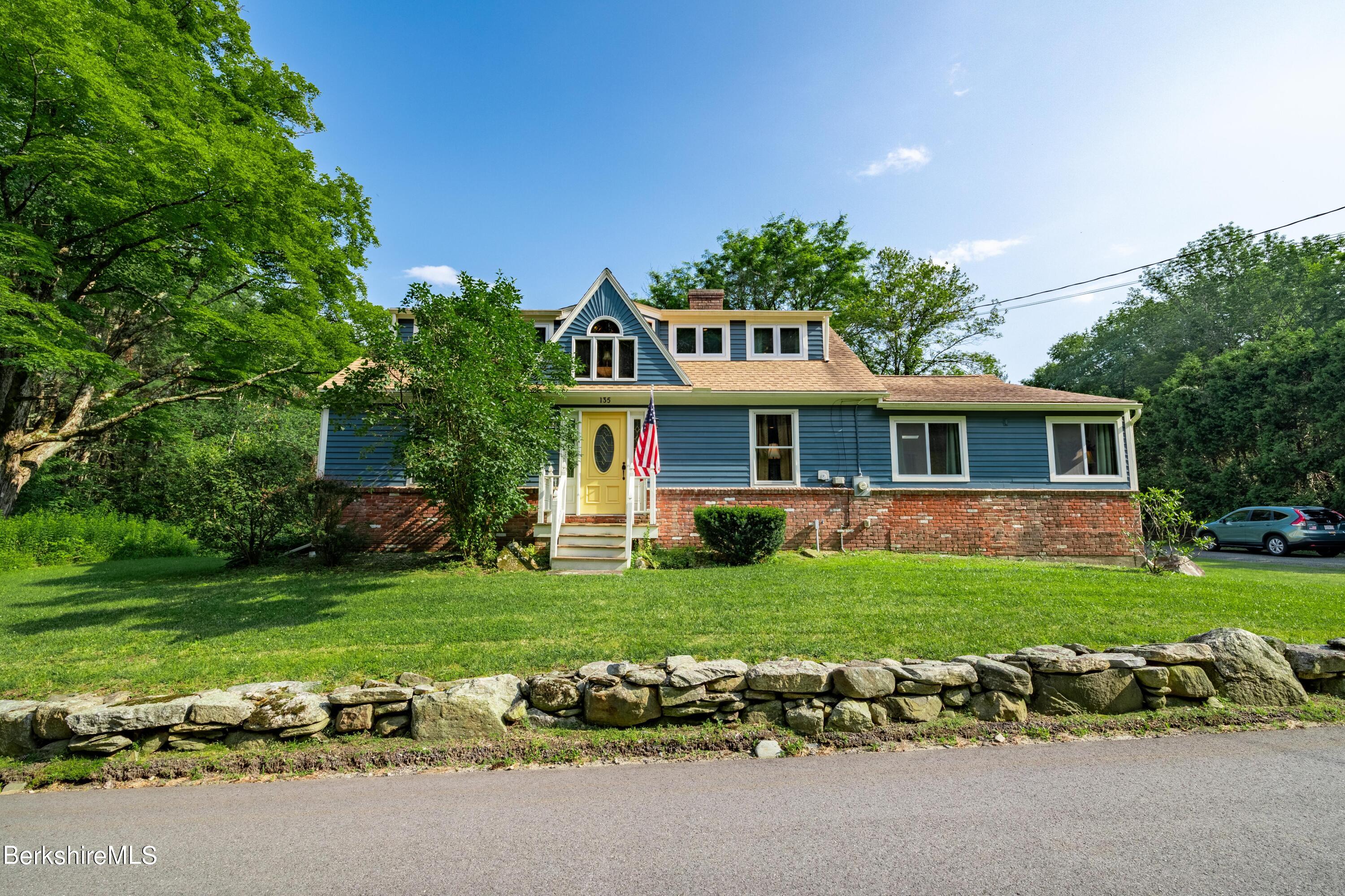 a front view of a house with a garden