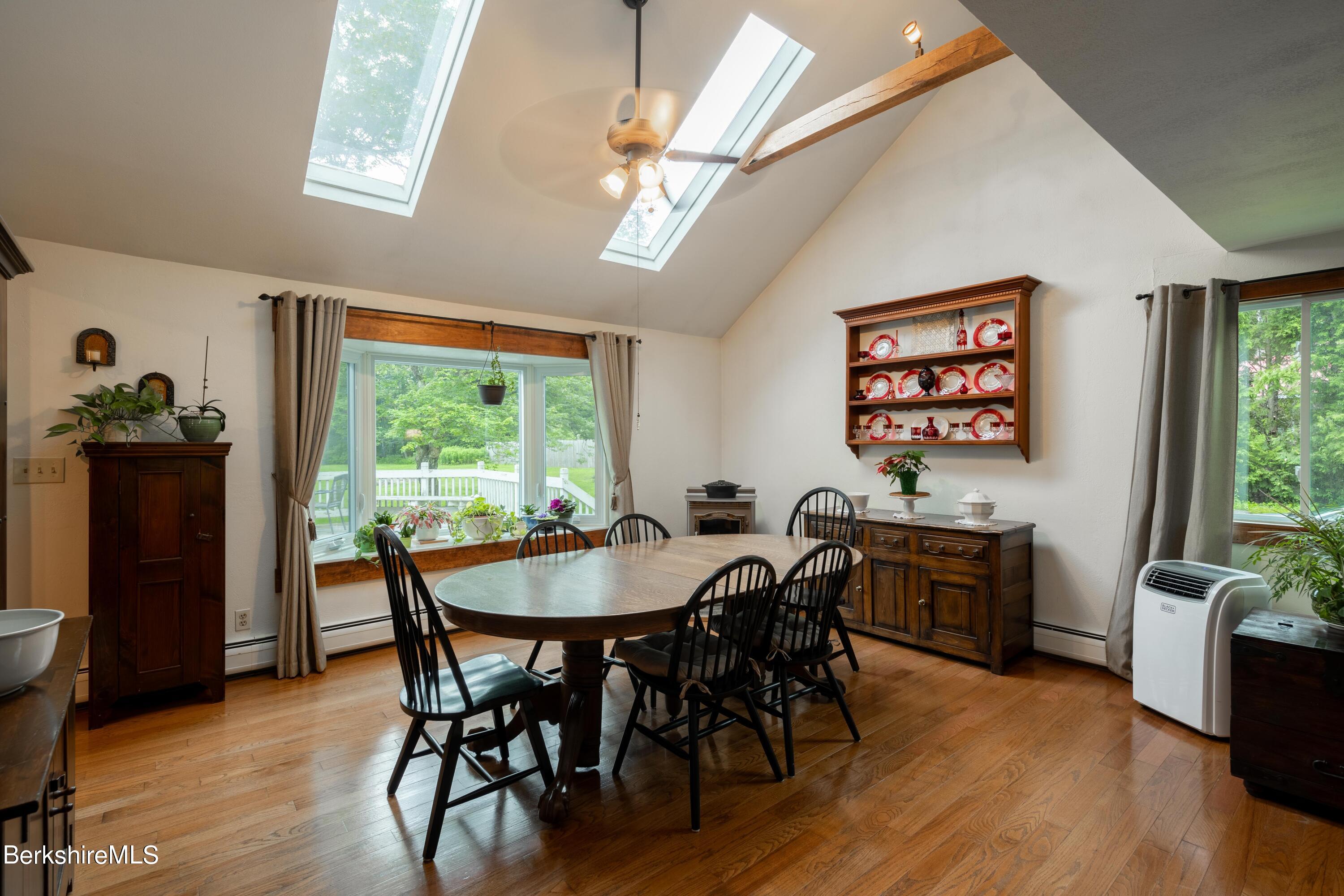 135 Ed Jones Road Otis, MA 01253 - Photo 16 of 45 a view of a dining room with furniture window and wooden floor