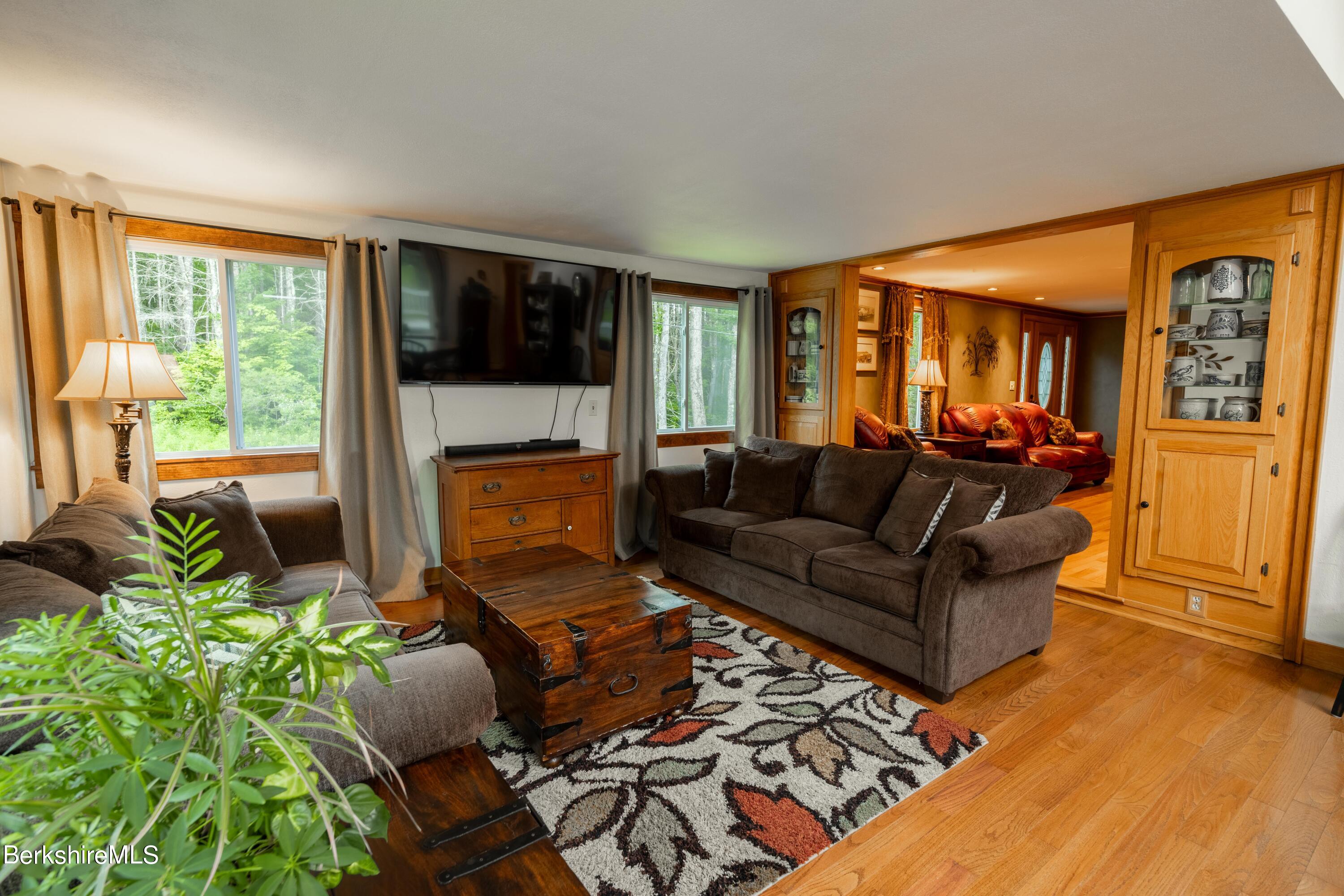 135 Ed Jones Road Otis, MA 01253 - Photo 19 of 45 a living room with furniture and a fireplace
