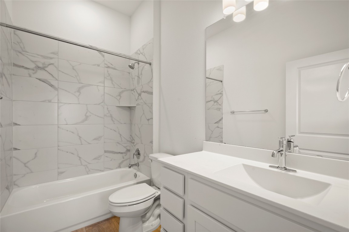 15004 Ryman Road Austin, TX 78660 - Photo 11 of 23 Bathroom featuring a combined bath / shower with marble appearance and vanity