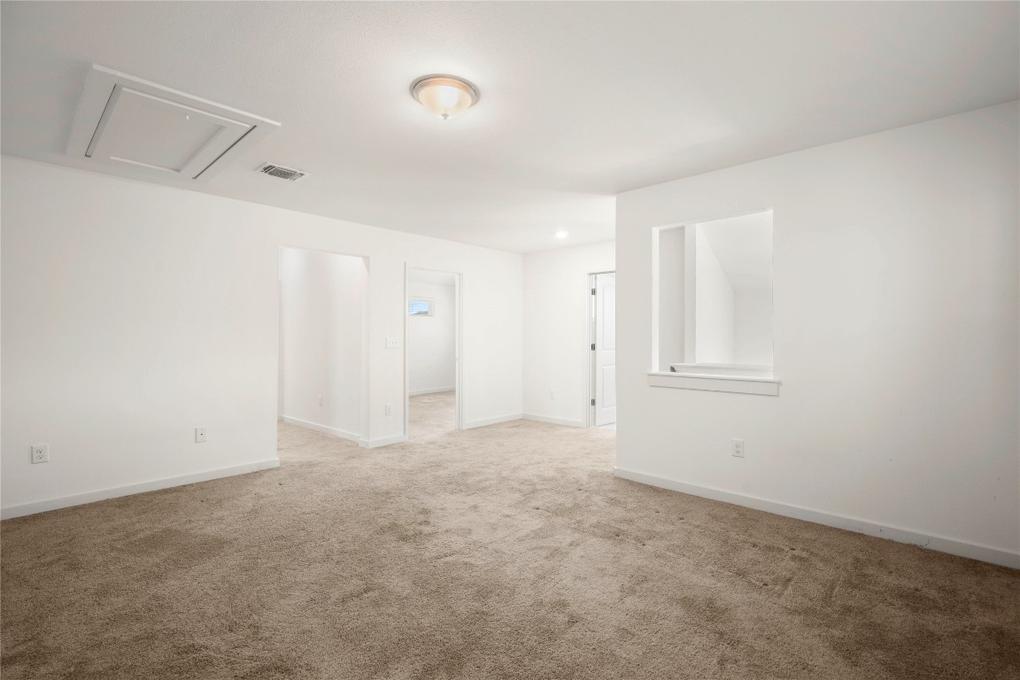 15004 Ryman Road Austin, TX 78660 - Photo 15 of 23 Carpeted spare room with baseboards and attic access