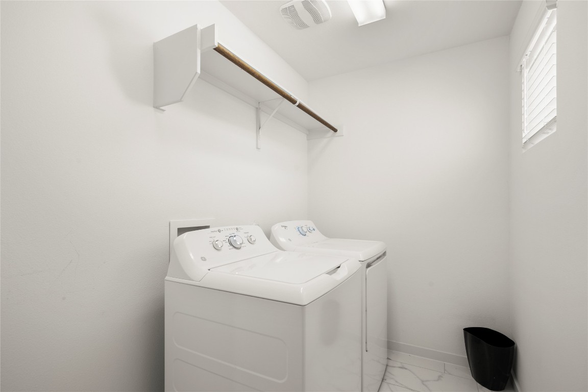 15004 Ryman Road Austin, TX 78660 - Photo 23 of 23 Laundry room featuring light marble finish floors and separate washer and dryer