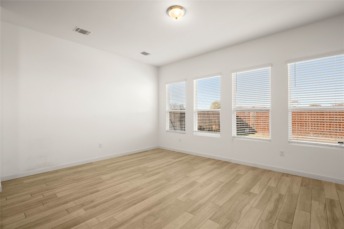 15004 Ryman Road Austin, TX 78660 - Photo 7 of 23 Empty room featuring light wood-style floors