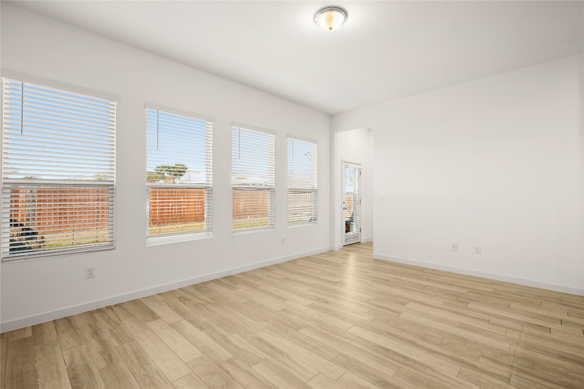 15004 Ryman Road Austin, TX 78660 - Photo 8 of 23 Unfurnished room featuring light wood-type flooring and baseboards