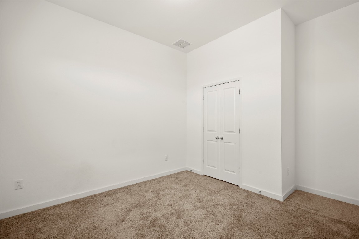 15004 Ryman Road Austin, TX 78660 - Photo 9 of 23 Unfurnished bedroom featuring carpet flooring and a closet