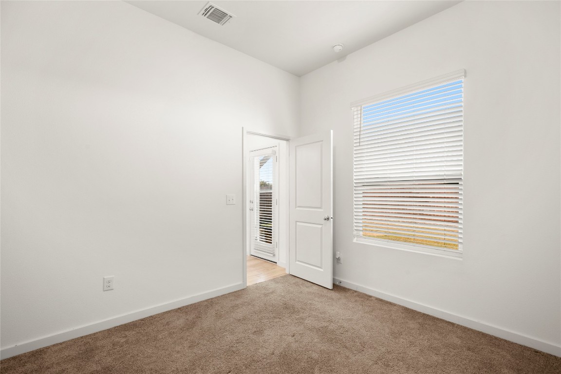 15004 Ryman Road Austin, TX 78660 - Photo 10 of 23 Unfurnished bedroom with baseboards and carpet floors