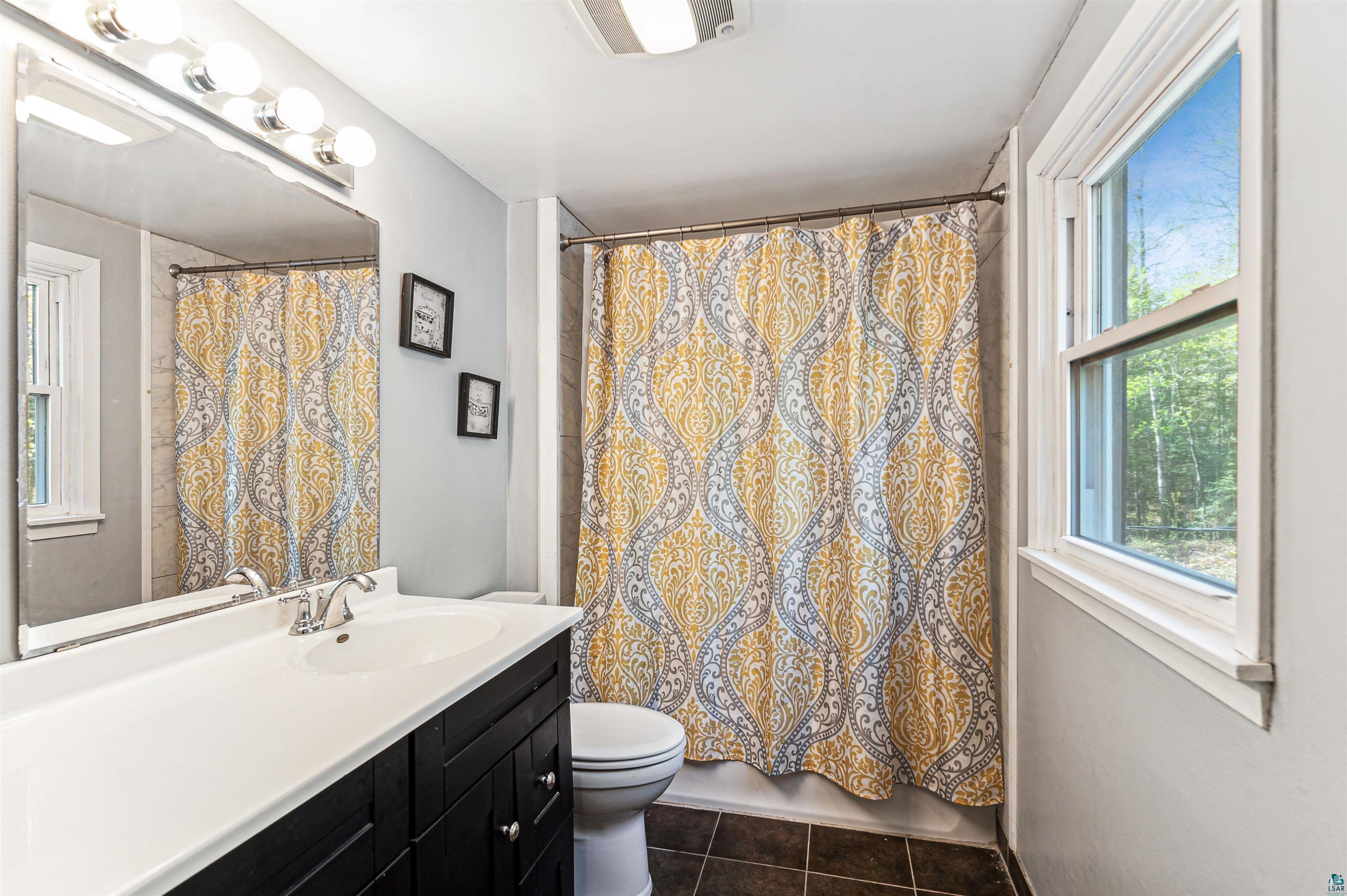 28 North Cloquet Road East Esko, MN 55733 - Photo 12 of 26 Bathroom with tile floors, toilet, and large vanity