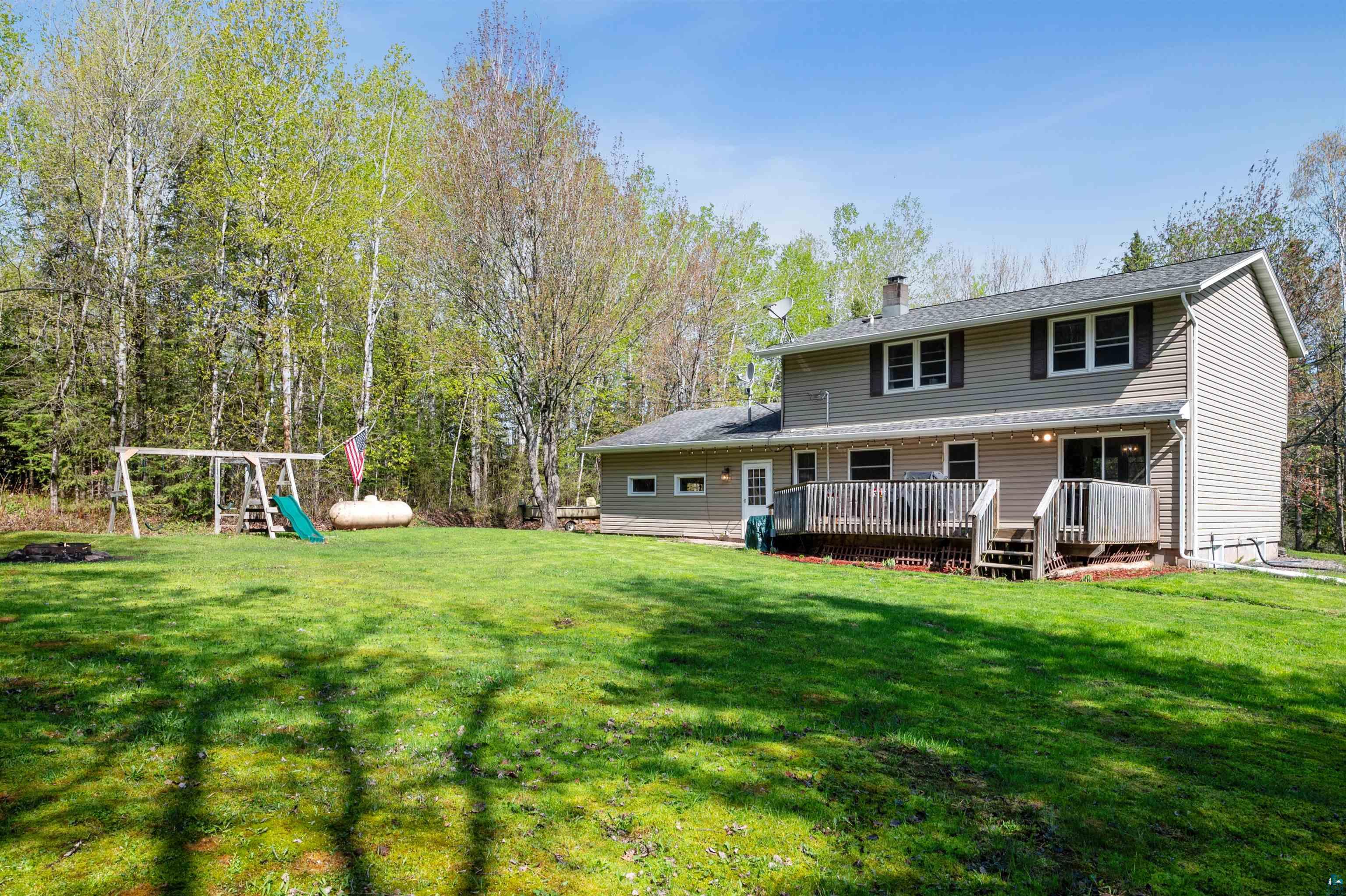 28 North Cloquet Road East Esko, MN 55733 - Photo 19 of 26 Rear view of house with a wooden deck and a yard