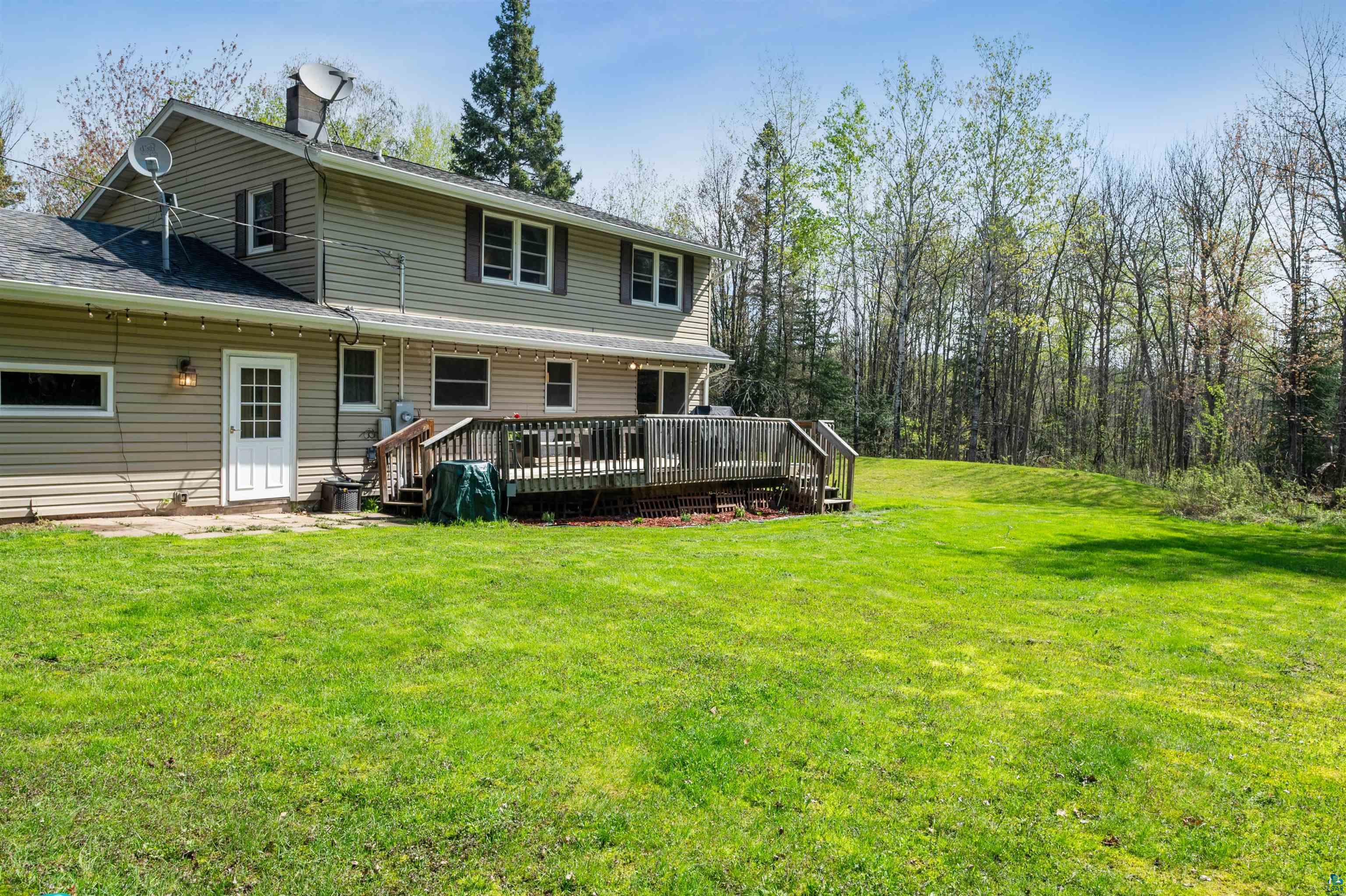 28 North Cloquet Road East Esko, MN 55733 - Photo 20 of 26 Back of house featuring a yard and a wooden deck