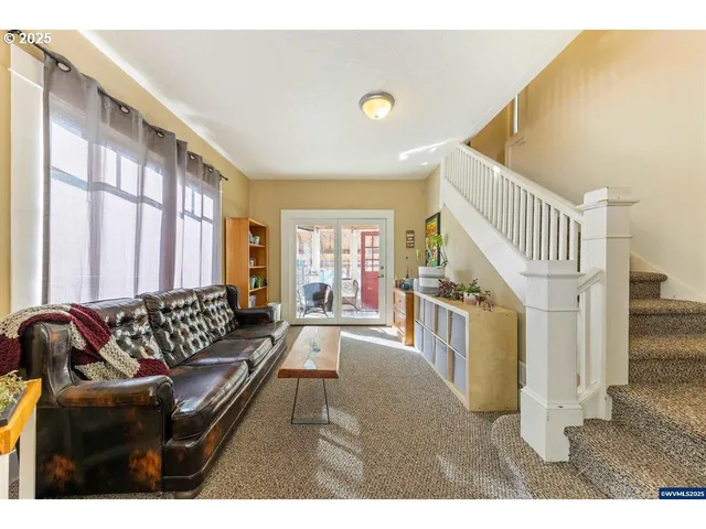 a living room with furniture and a floor to ceiling window