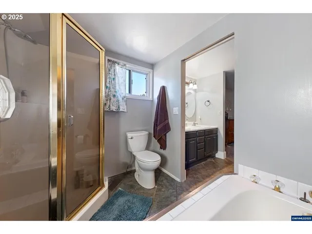 a bathroom with a bathtub shower sink and toilet