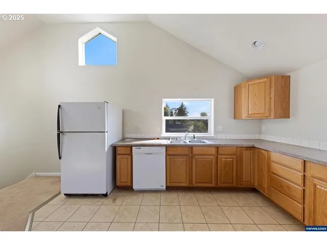 a kitchen with stainless steel appliances a refrigerator sink and stove