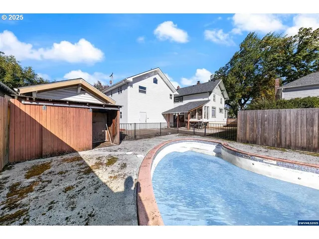 a view of a house with wooden fence