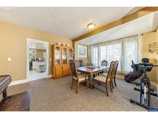 a view of a dining room with furniture and window
