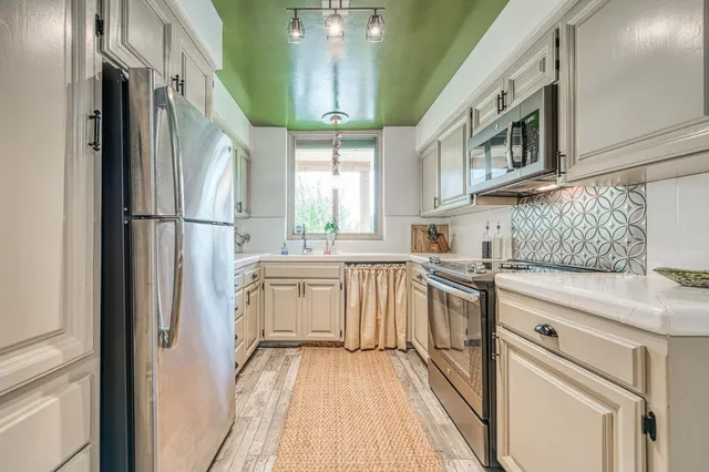 a kitchen with cabinets and stainless steel appliances