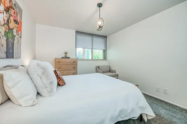 a bedroom with a bed and a window