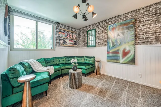 a living room with furniture and a potted plant