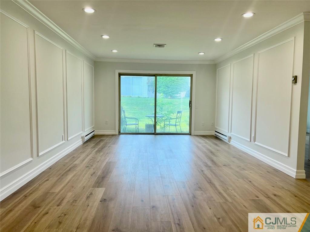 267 Glen Road, Unit 267B Monroe Township, NJ 08831 - Photo 13 of 26 a view of an empty room with wooden floor and a window