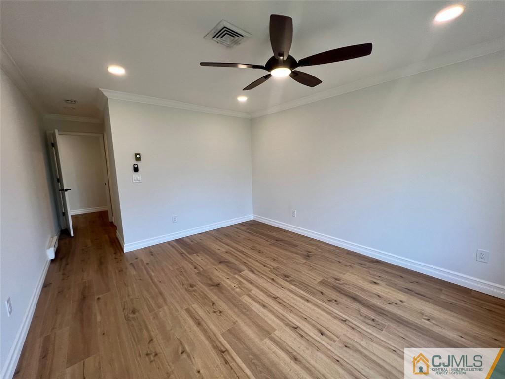 267 Glen Road, Unit 267B Monroe Township, NJ 08831 - Photo 17 of 26 wooden floor in an empty room with a window