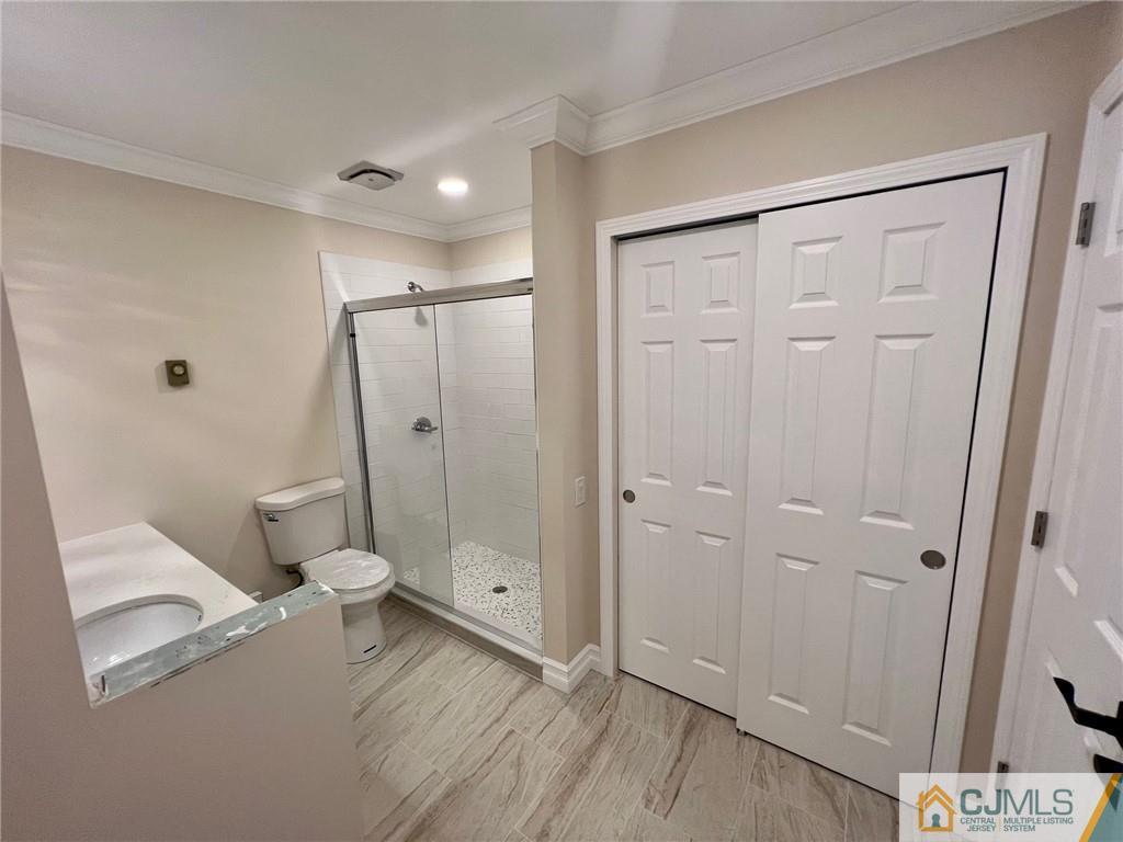 267 Glen Road, Unit 267B Monroe Township, NJ 08831 - Photo 19 of 26 a bathroom with a sink a toilet and shower