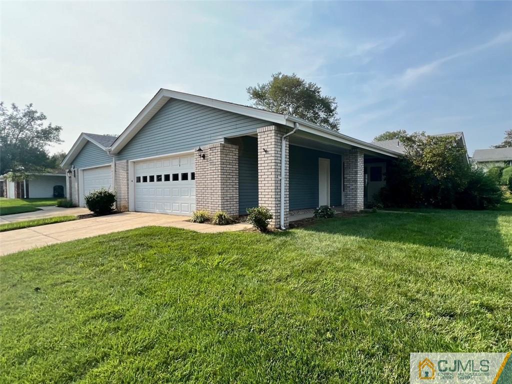 267 Glen Road, Unit 267B Monroe Township, NJ 08831 - Photo 2 of 26 a front view of house with yard and green space