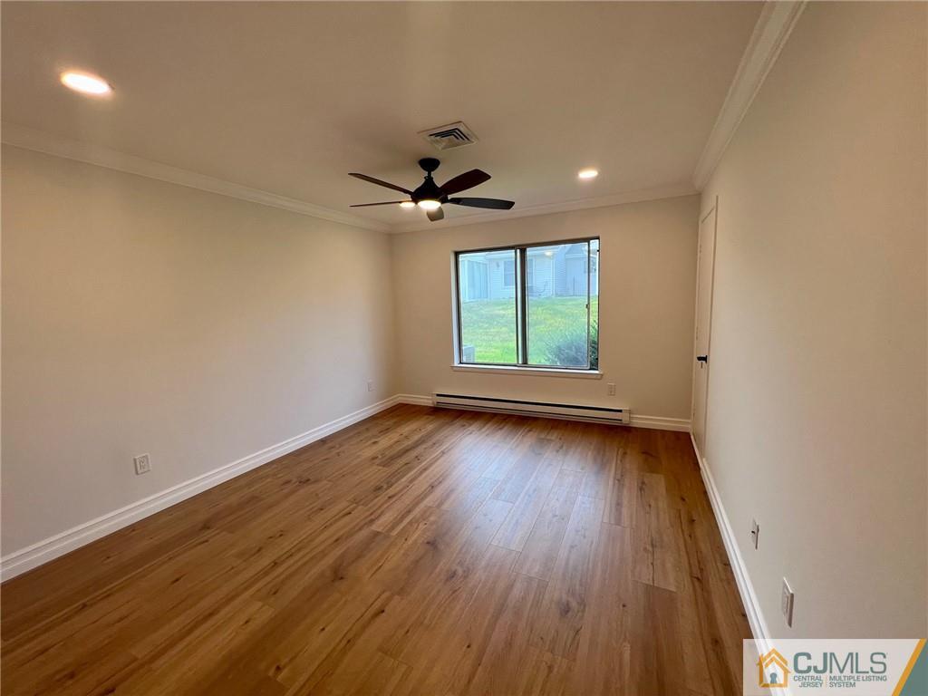 267 Glen Road, Unit 267B Monroe Township, NJ 08831 - Photo 24 of 26 wooden floor in an empty room with a window