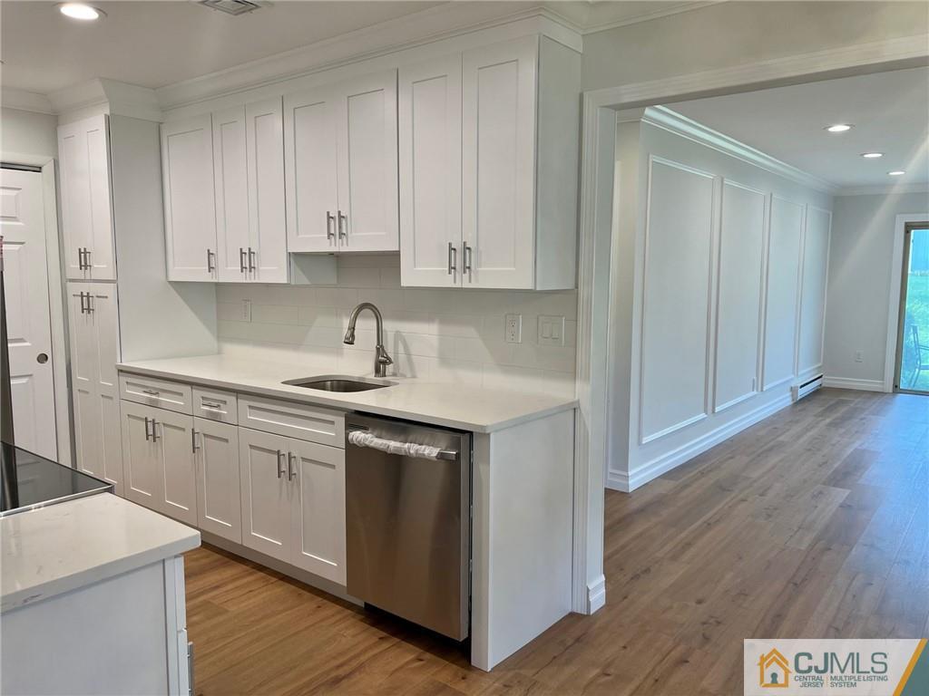 267 Glen Road, Unit 267B Monroe Township, NJ 08831 - Photo 7 of 26 a kitchen with cabinets appliances and a wooden floor