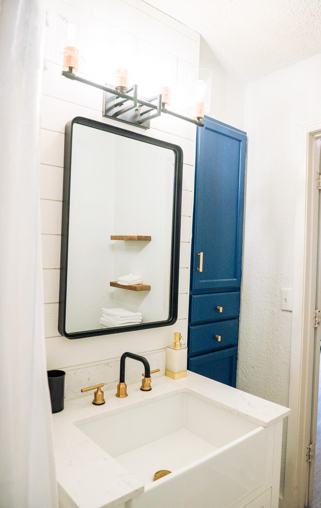 2436 24th Street Lubbock, TX 79411 - Photo 14 of 29 a bathroom with a sink and a mirror